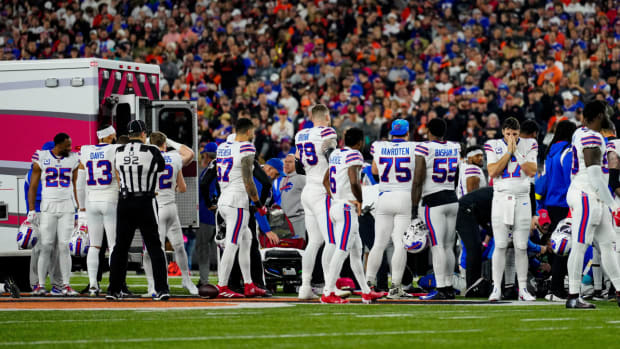 Bills players watch on as safety Damar Hamlin is taken in an ambulance off the field.